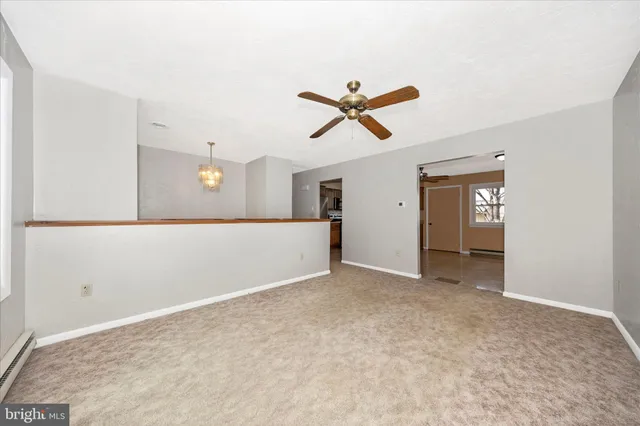 a view of a big room with wooden floor and windows