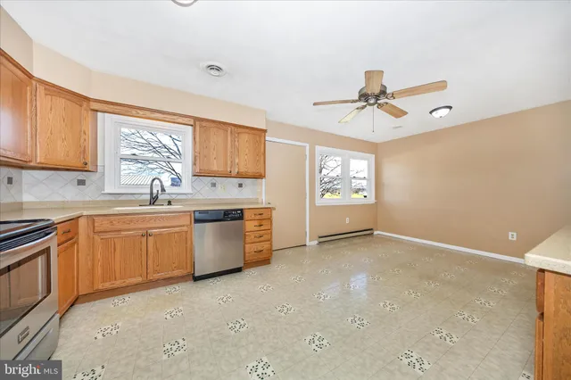 a kitchen with a refrigerator a sink and dishwasher with a dishwasher