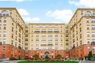 a front view of a building with a garden