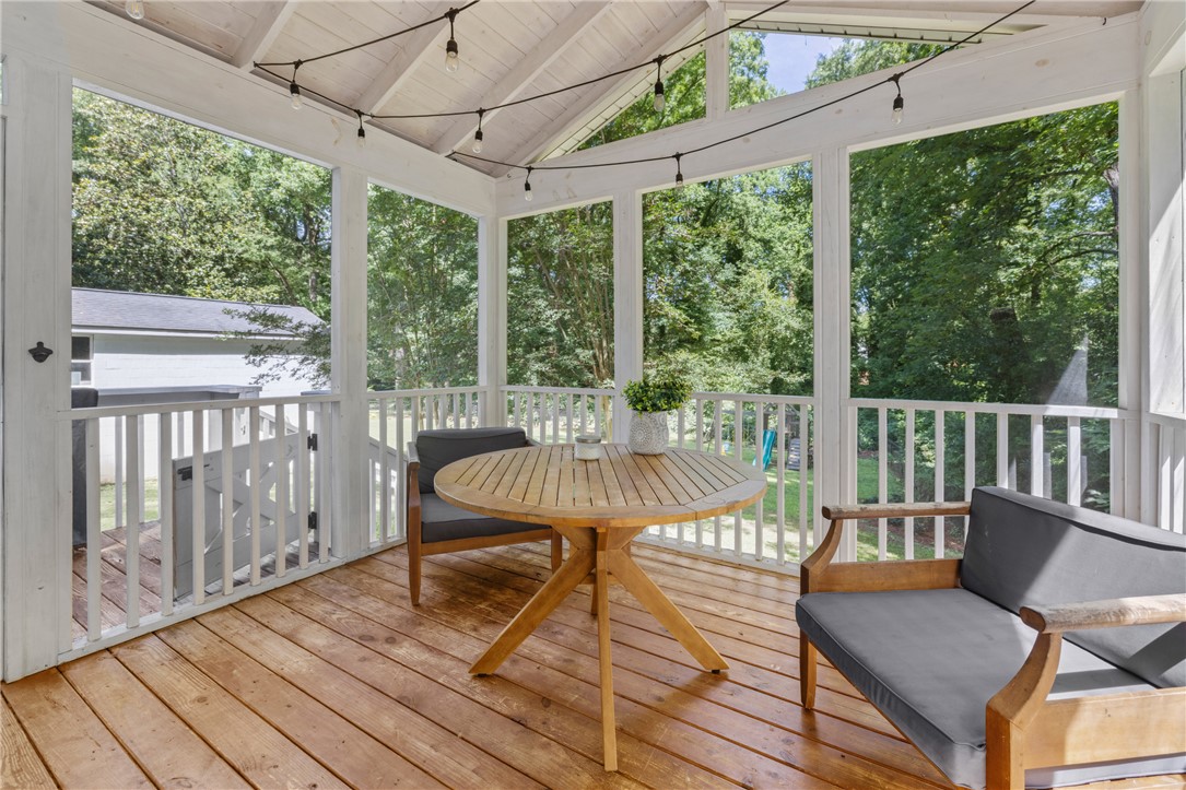 203 Augusta Road Clemson, SC 29631 - Photo 12 of 31 A breezy screened porch offers peaceful wooded views, perfect for unwinding outdoors.