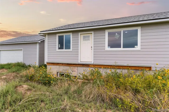 a view of house with backyard and garden