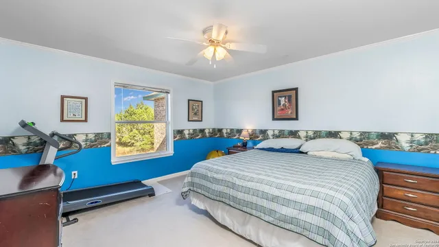 a bedroom with a bed couch and wooden floor