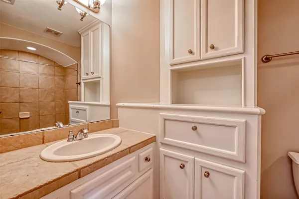 a bathroom with a sink vanity and a mirror