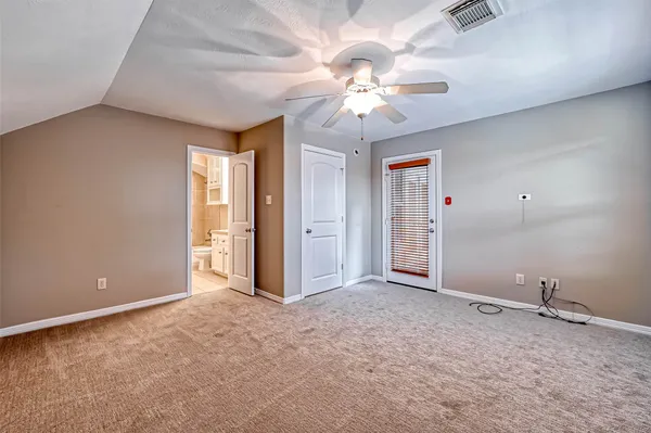 a view of an empty room with a chandelier fan