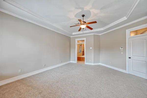 an empty room with window and a ceiling fan