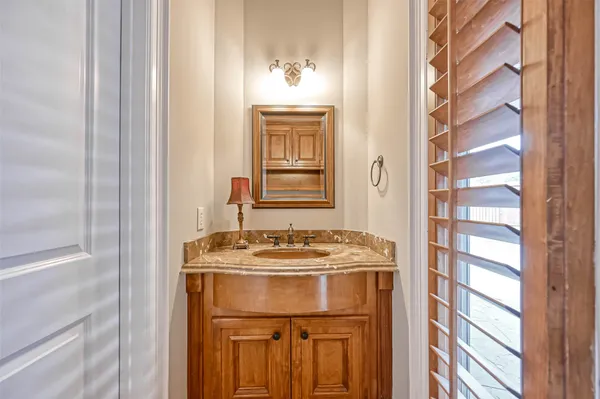 a bathroom with a sink a mirror and a window