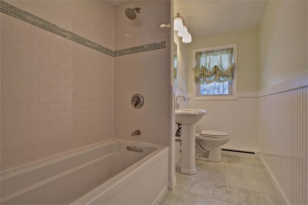 45 Gregory Road Framingham, MA 01701 - Photo 17 of 27 a bathroom with a toilet and a bathtub