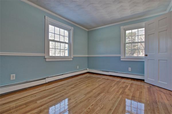 45 Gregory Road Framingham, MA 01701 - Photo 18 of 27 an empty room with wooden floor and windows
