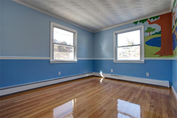 45 Gregory Road Framingham, MA 01701 - Photo 21 of 27 a view of an empty room with wooden floor and a window