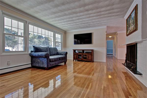 45 Gregory Road Framingham, MA 01701 - Photo 3 of 27 a living room with furniture and a flat screen tv