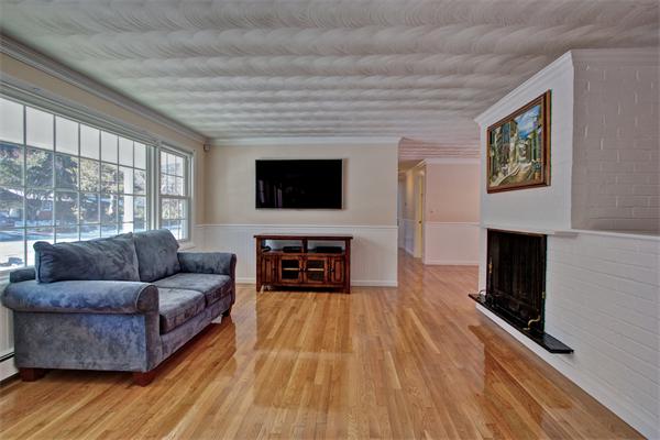 45 Gregory Road Framingham, MA 01701 - Photo 4 of 27 a living room with furniture a fireplace and a flat screen tv
