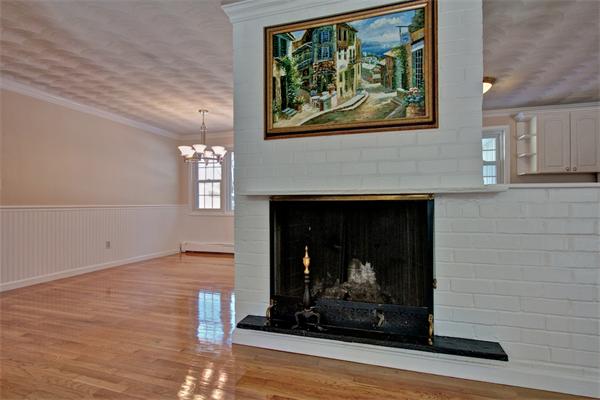 45 Gregory Road Framingham, MA 01701 - Photo 6 of 27 an empty room with fireplace and wooden floor