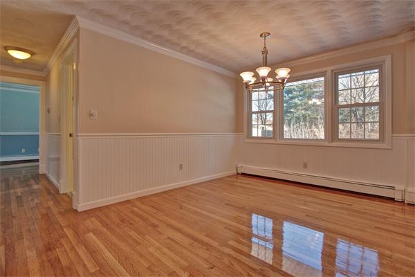 45 Gregory Road Framingham, MA 01701 - Photo 8 of 27 an empty room with wooden floor and windows