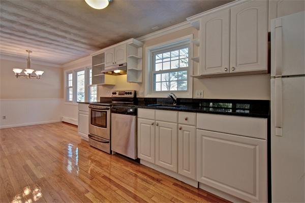 45 Gregory Road Framingham, MA 01701 - Photo 10 of 27 a kitchen with granite countertop white cabinets and black appliances