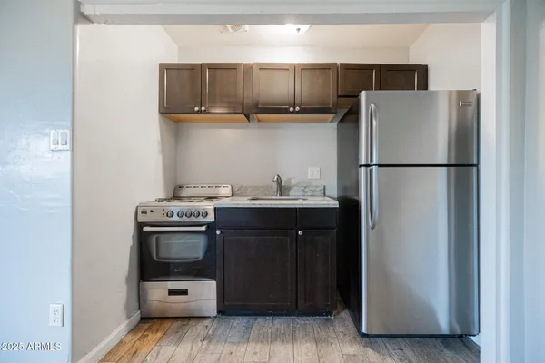 a kitchen with stainless steel appliances a refrigerator and a stove top oven
