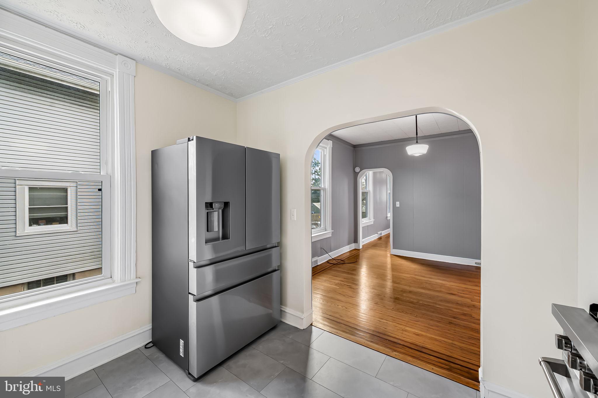 304 West Cold Spring Lane Baltimore, MD 21210 - Photo 13 of 34 Modern kitchen with inviting archway.