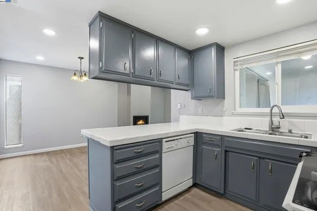 a kitchen with a sink stainless steel appliances and cabinets