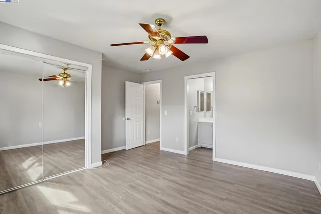 a view of an empty room and window with wooden floor