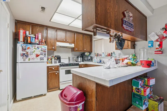 a kitchen with a sink a cabinets and appliances
