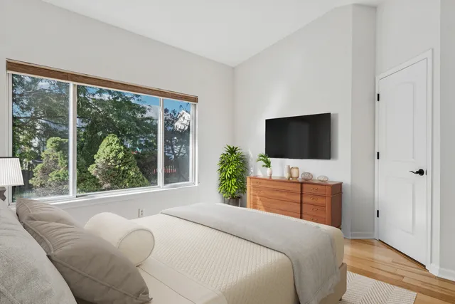 a bedroom with a flat screen tv and a bed