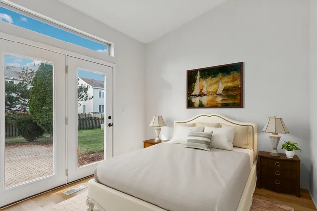 a bedroom with a bed and a painting on the wall