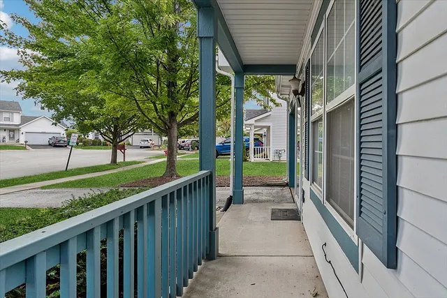 a view of a pathway of a house next to a yard