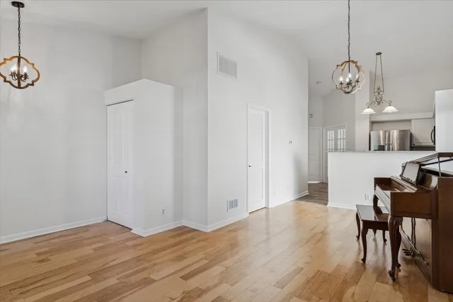 a view of a room with wooden floor and furniture
