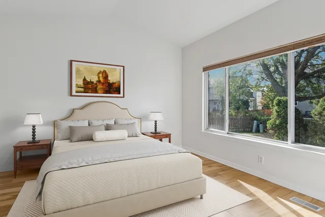 a bedroom with a bed and a large window