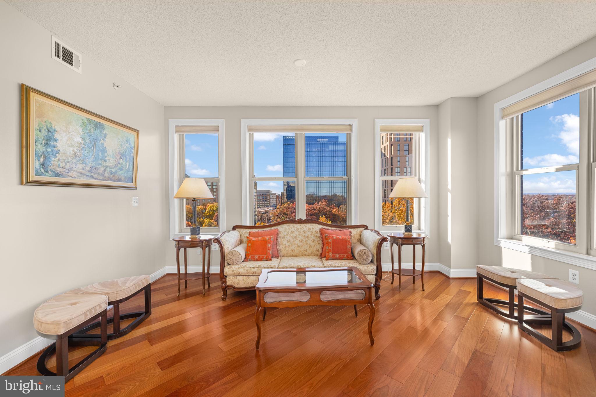 11776 Stratford House Place, Unit 907 Reston, VA 20190 - Photo 11 of 38 a living room with furniture and a wooden floor