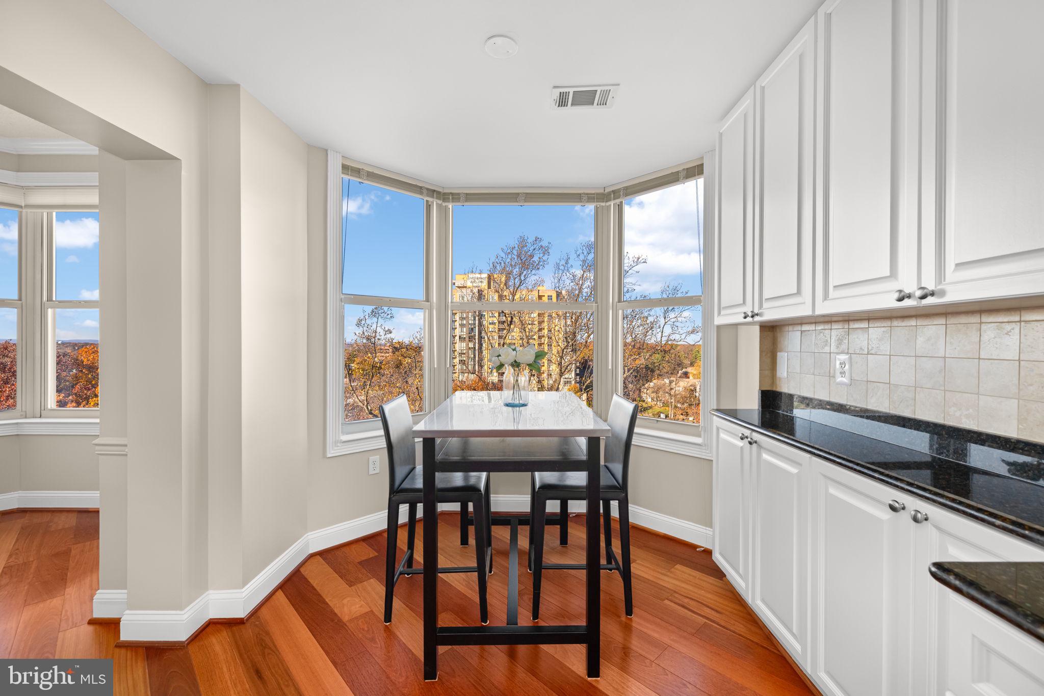 11776 Stratford House Place, Unit 907 Reston, VA 20190 - Photo 14 of 38 a view of a dining room with furniture window and wooden floor