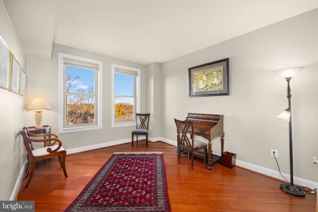 a bathroom with a granite countertop sink mirror vanity and toilet