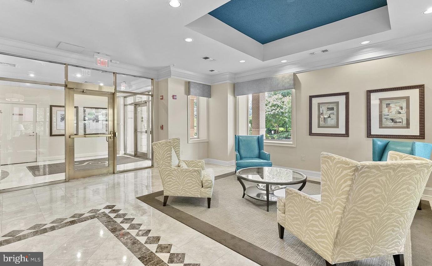 11776 Stratford House Place, Unit 907 Reston, VA 20190 - Photo 29 of 38 a living room with furniture and a large window