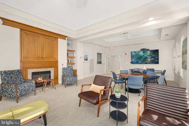 a living room with furniture fireplace and window