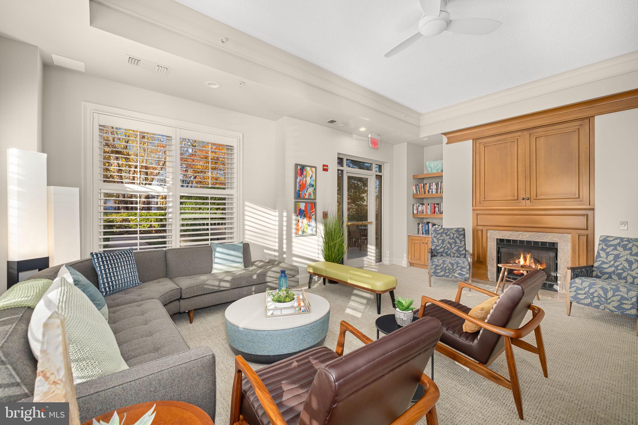 11776 Stratford House Place, Unit 907 Reston, VA 20190 - Photo 33 of 38 a living room with fireplace furniture and a large window