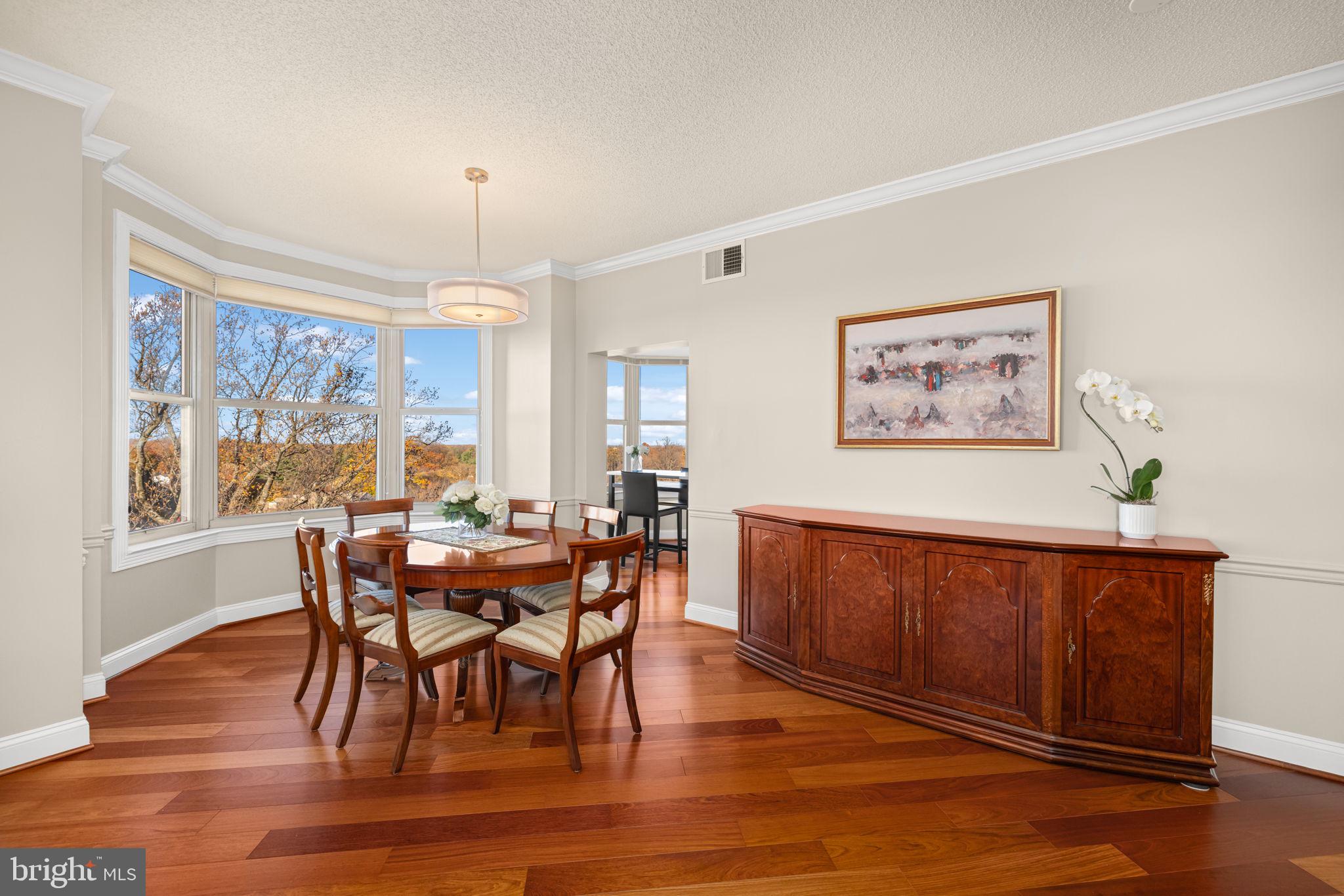 11776 Stratford House Place, Unit 907 Reston, VA 20190 - Photo 5 of 38 a view of a dining room with furniture window and wooden floor