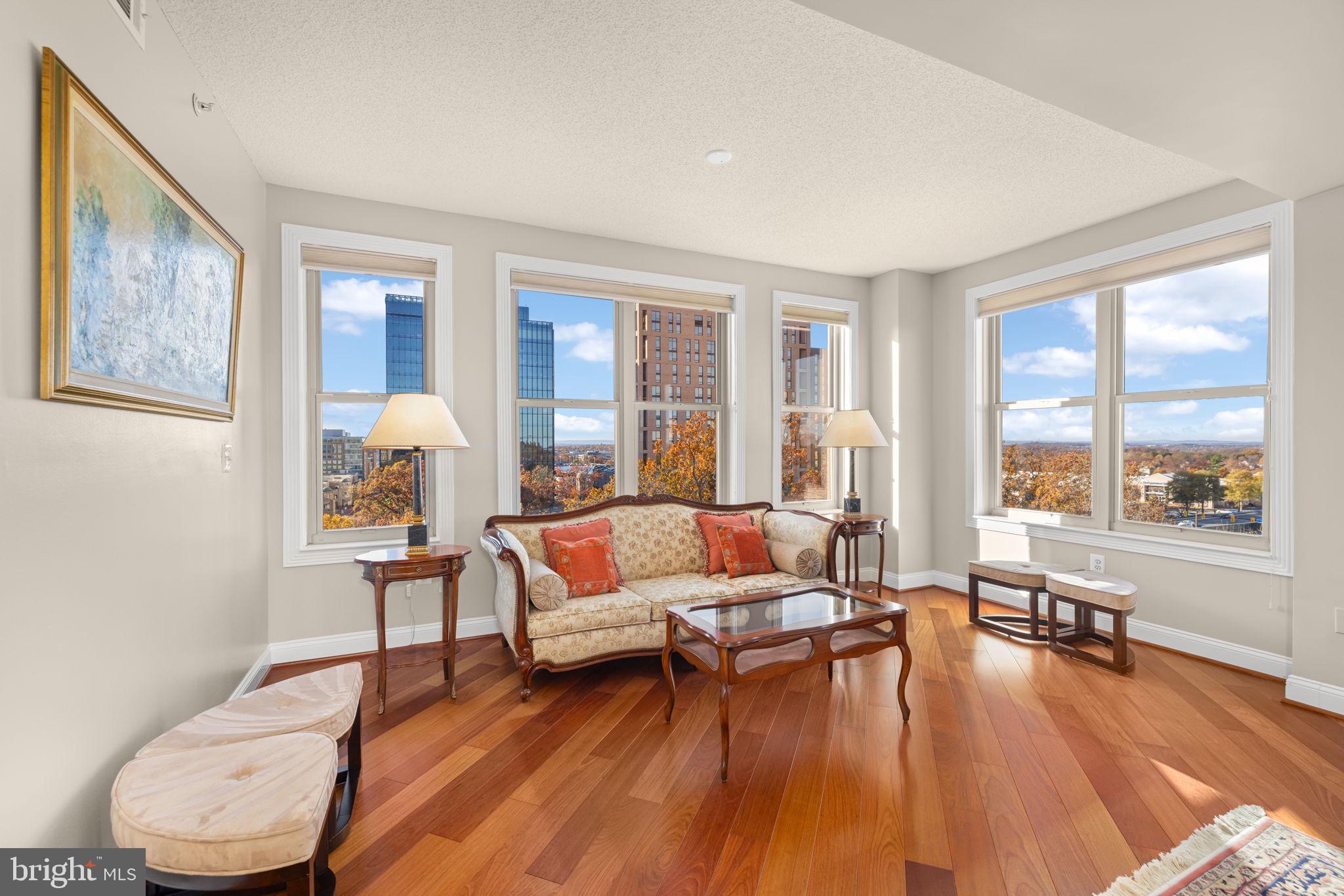 11776 Stratford House Place, Unit 907 Reston, VA 20190 - Photo 8 of 38 a living room with furniture and a large window
