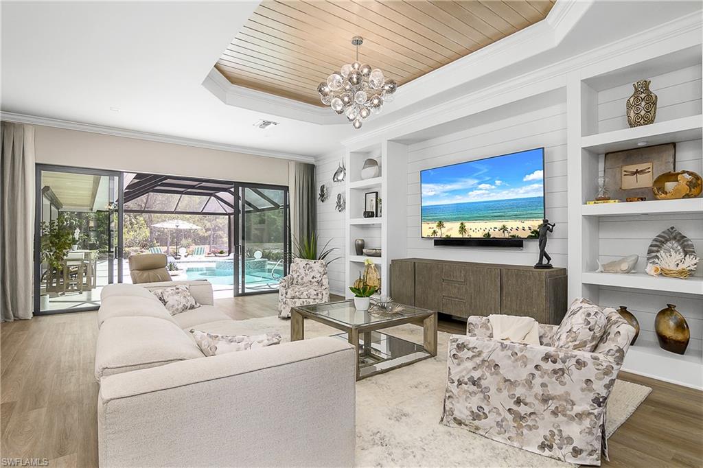 9489 Italia Way Naples, FL 34113 - Photo 12 of 50 a living room with furniture and a chandelier