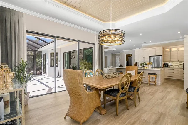 a view of a dining room with furniture wooden floor and chandelier