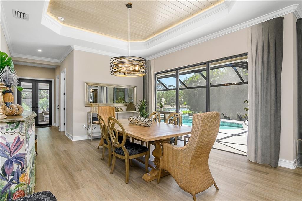 9489 Italia Way Naples, FL 34113 - Photo 14 of 50 a view of a dining room with furniture window and wooden floor