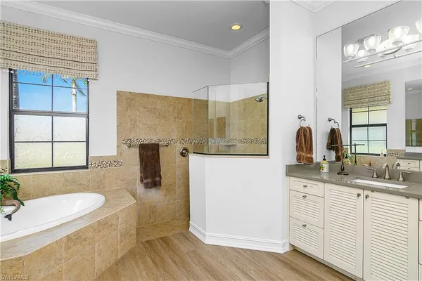 a spacious bathroom with a granite countertop tub sink and mirror