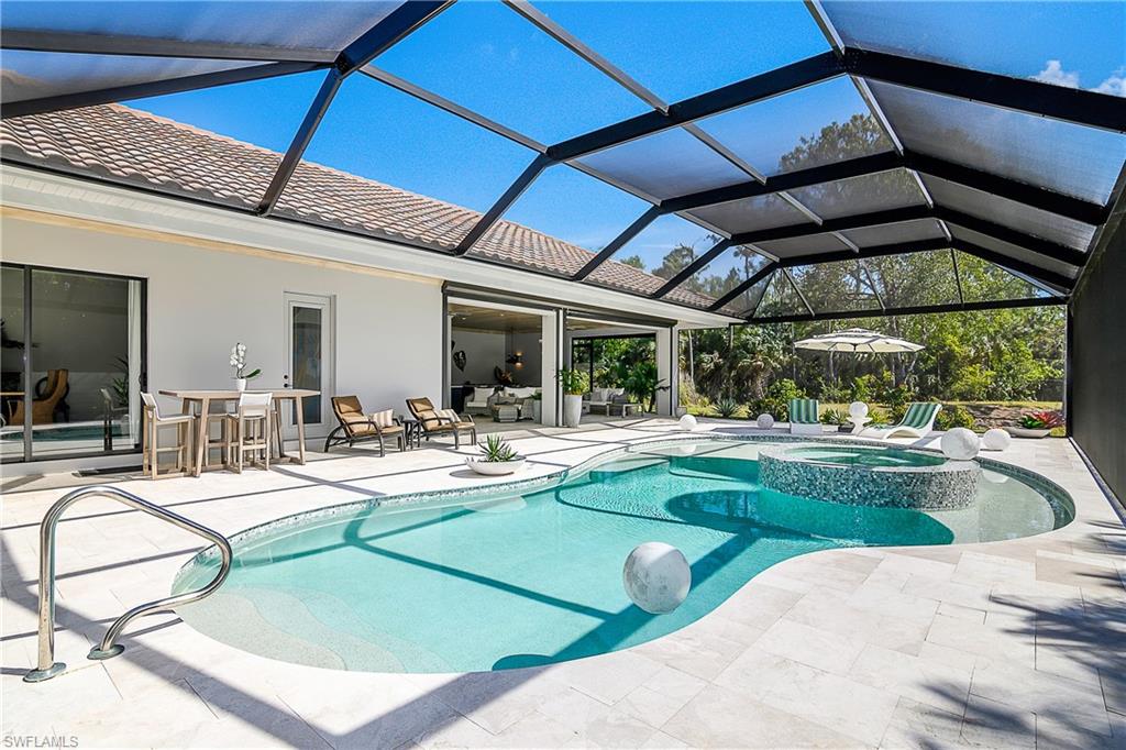 9489 Italia Way Naples, FL 34113 - Photo 24 of 50 a view of a swimming pool with a patio