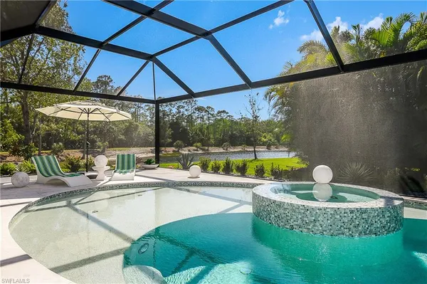 a view of a swimming pool with a yard and sitting space