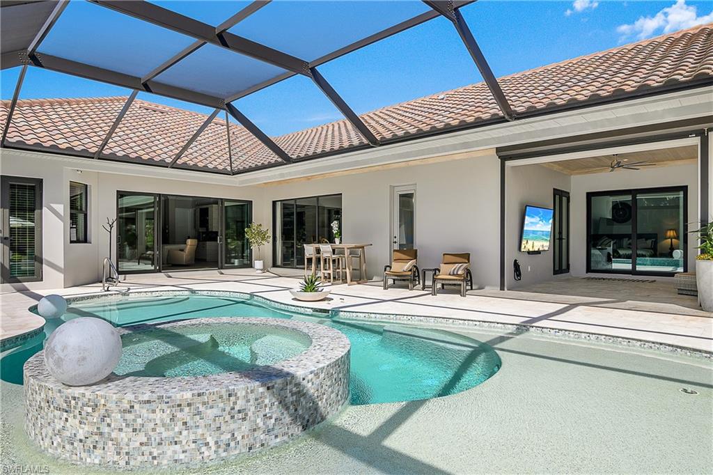 9489 Italia Way Naples, FL 34113 - Photo 27 of 50 a living room with furniture and a dining table