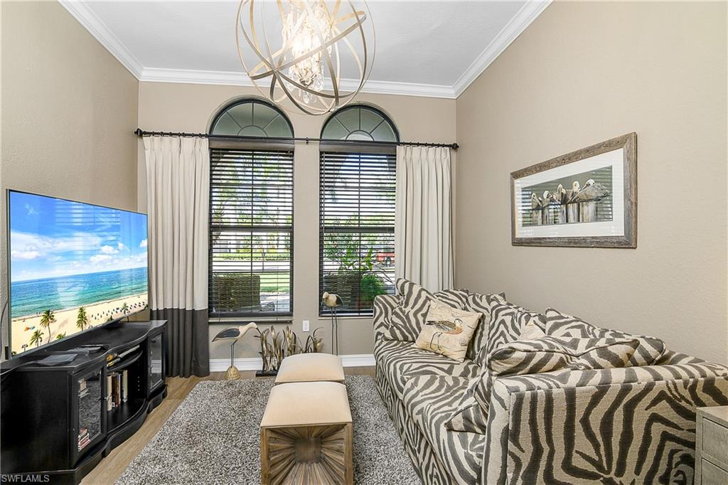 9489 Italia Way Naples, FL 34113 - Photo 3 of 50 a living room with furniture and a flat screen tv