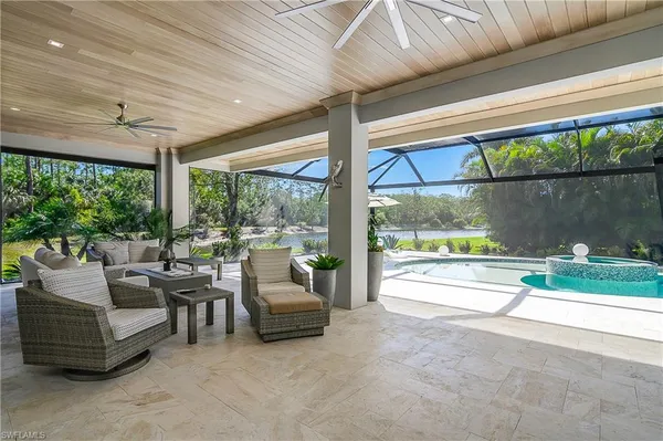 a living room with furniture and floor to ceiling windows