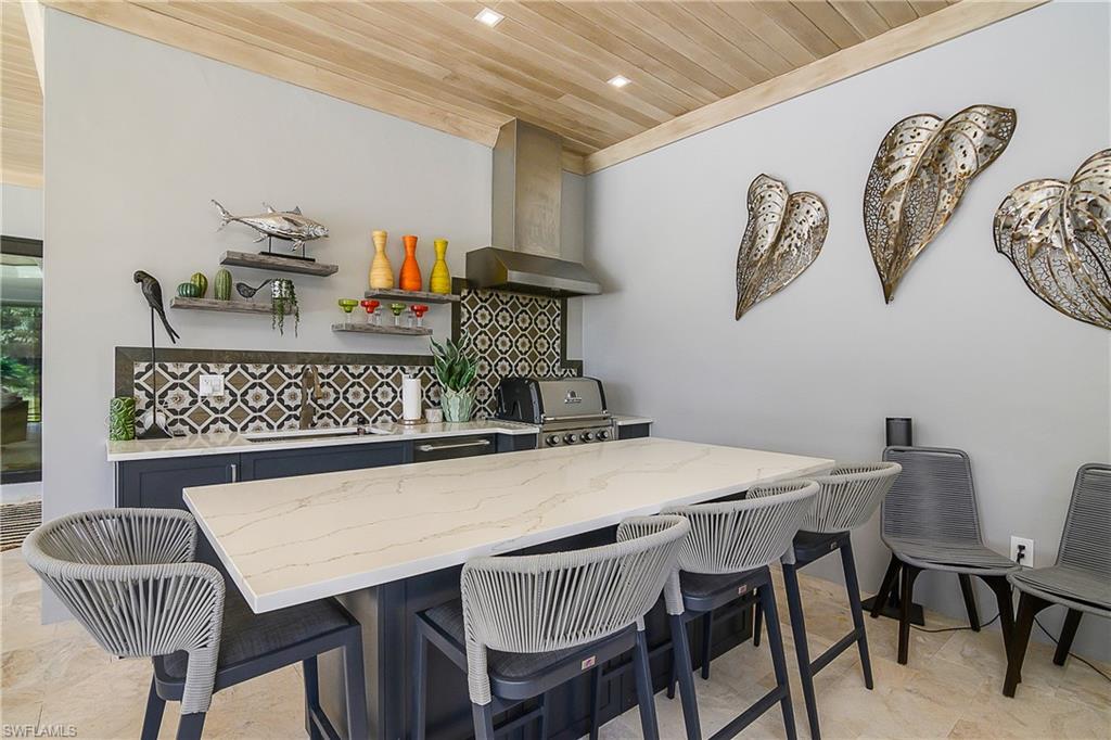 9489 Italia Way Naples, FL 34113 - Photo 33 of 50 a kitchen with a table and chairs