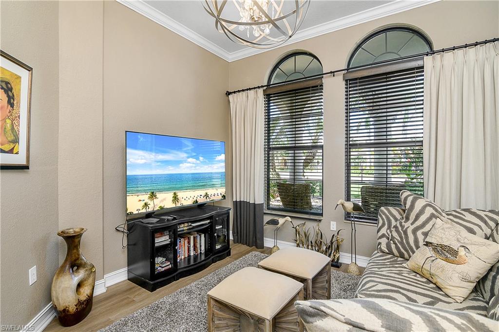 9489 Italia Way Naples, FL 34113 - Photo 4 of 50 a living room with furniture and a flat screen tv