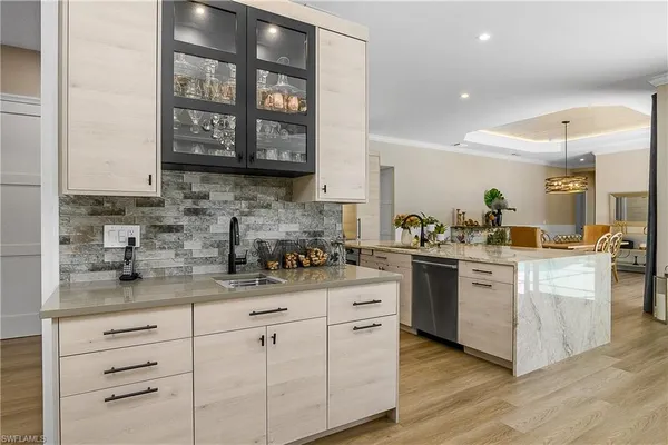 a kitchen with stainless steel appliances granite countertop a sink stove and cabinets