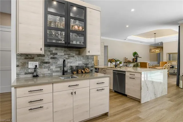 a kitchen with stainless steel appliances granite countertop a sink stove and cabinets