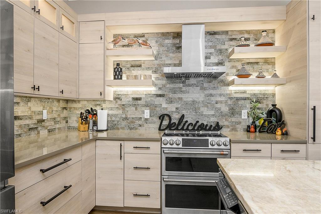 9489 Italia Way Naples, FL 34113 - Photo 7 of 50 a kitchen with cabinets and appliances